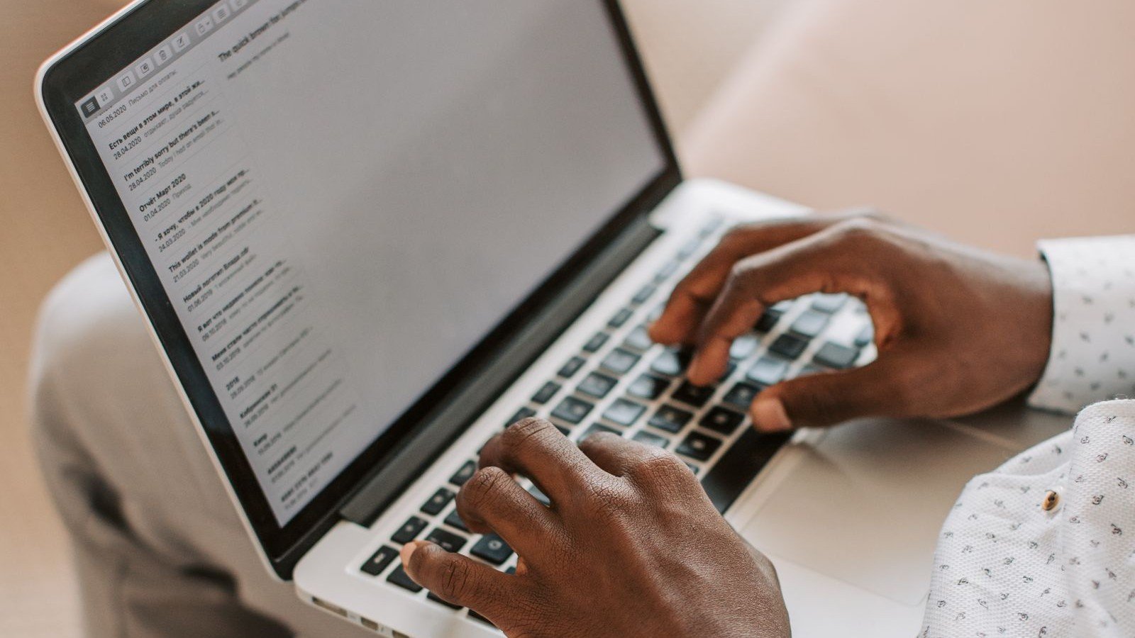 Hands typing an email on a laptop for link building outreach
