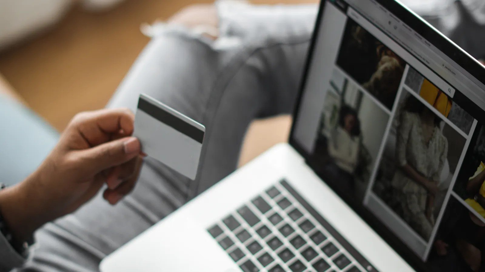 Person using a credit card to shop online on a laptop showing an optimized product page
